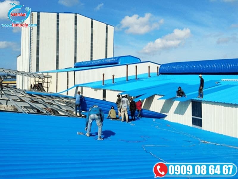 Công nhân đang thi công lắp đặt các tấm panel cách nhiệt màu xanh dương